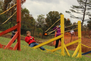 Young visitor to ColorFest experiences the joy of launching a pumpkin into the field at one of the new events for 2014.