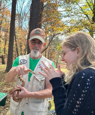 Volunteer with a corn snake